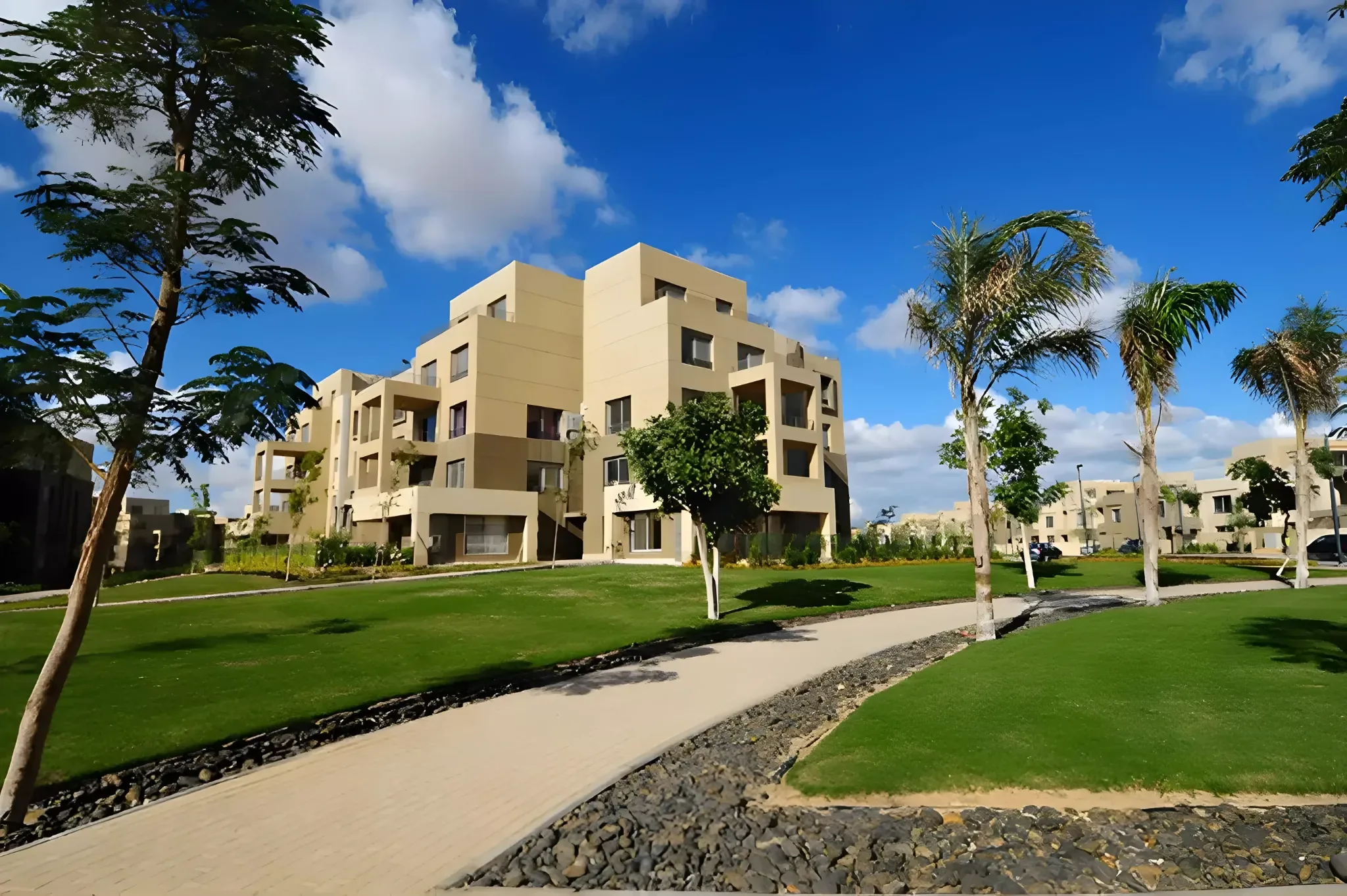 Landscaped walkway and apartment buildings at Palm Parks
