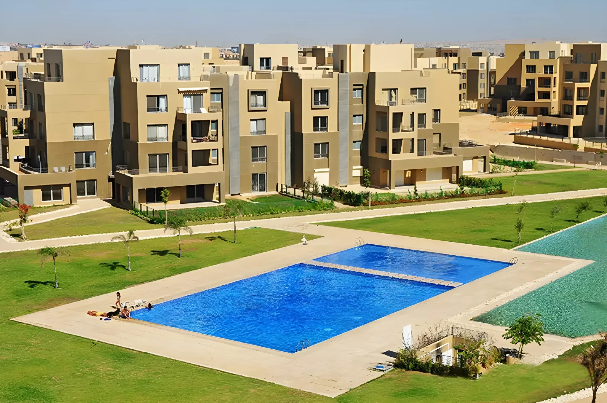 Swimming pool and residential buildings at Palm Parks